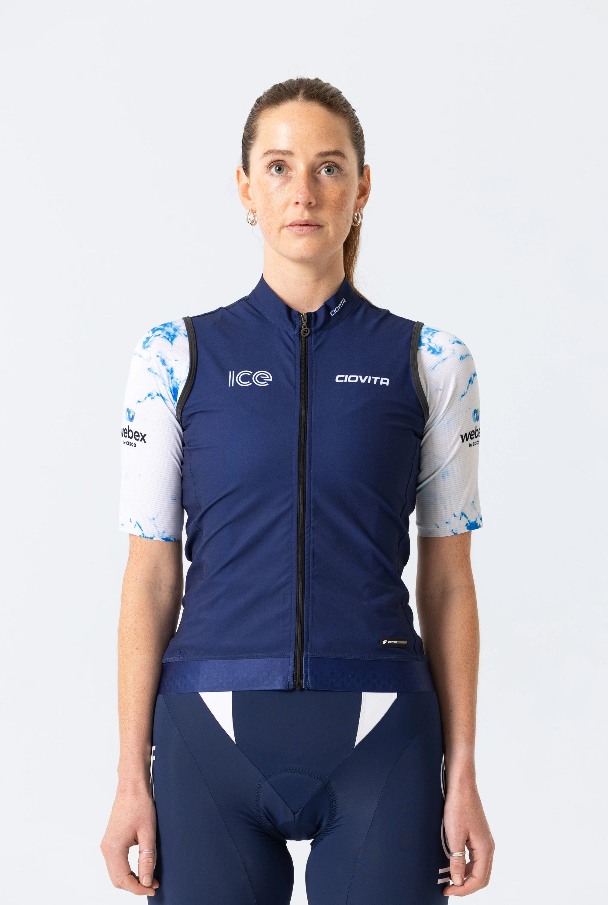 Person wearing a blue cycling outfit with visible branding on a white background