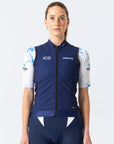 Person wearing a blue cycling outfit with visible branding on a white background