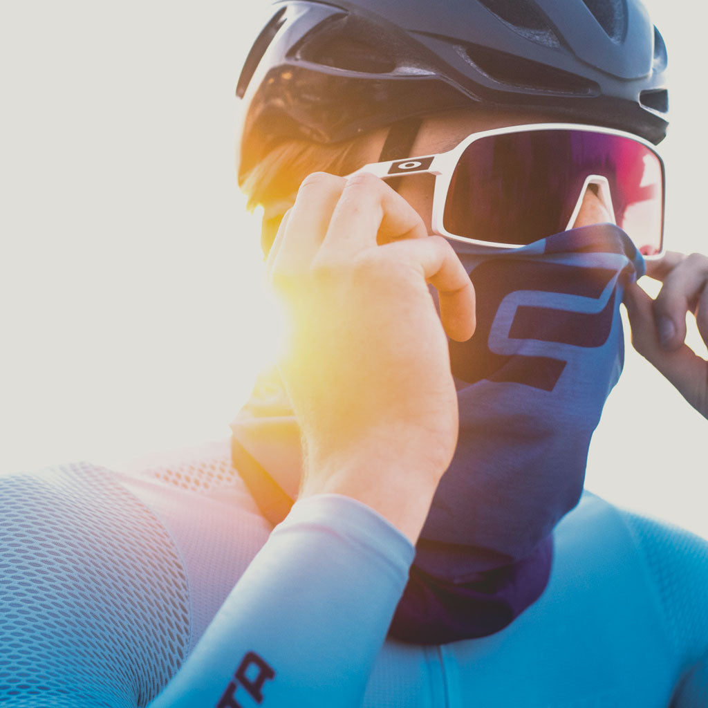 cyclist wearing blue headscarf over mouth